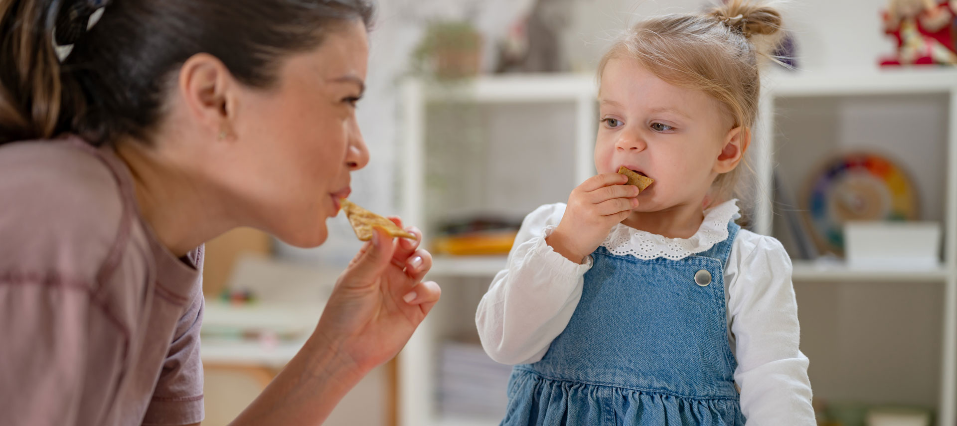 Mother daughter eating chips